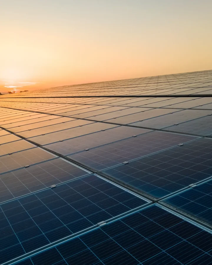 blue-photovoltaic-solar-panels-mounted-building-roof-producing-clean-ecological-electricity-sunset-production-renewable-energy-concept